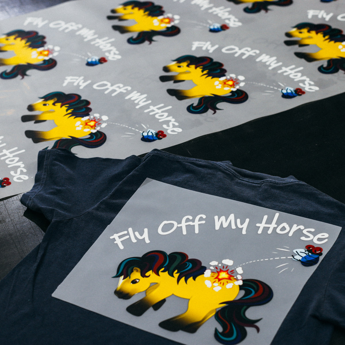 Custom DTF transfer gang sheet next to a t-shirt pressed with the design